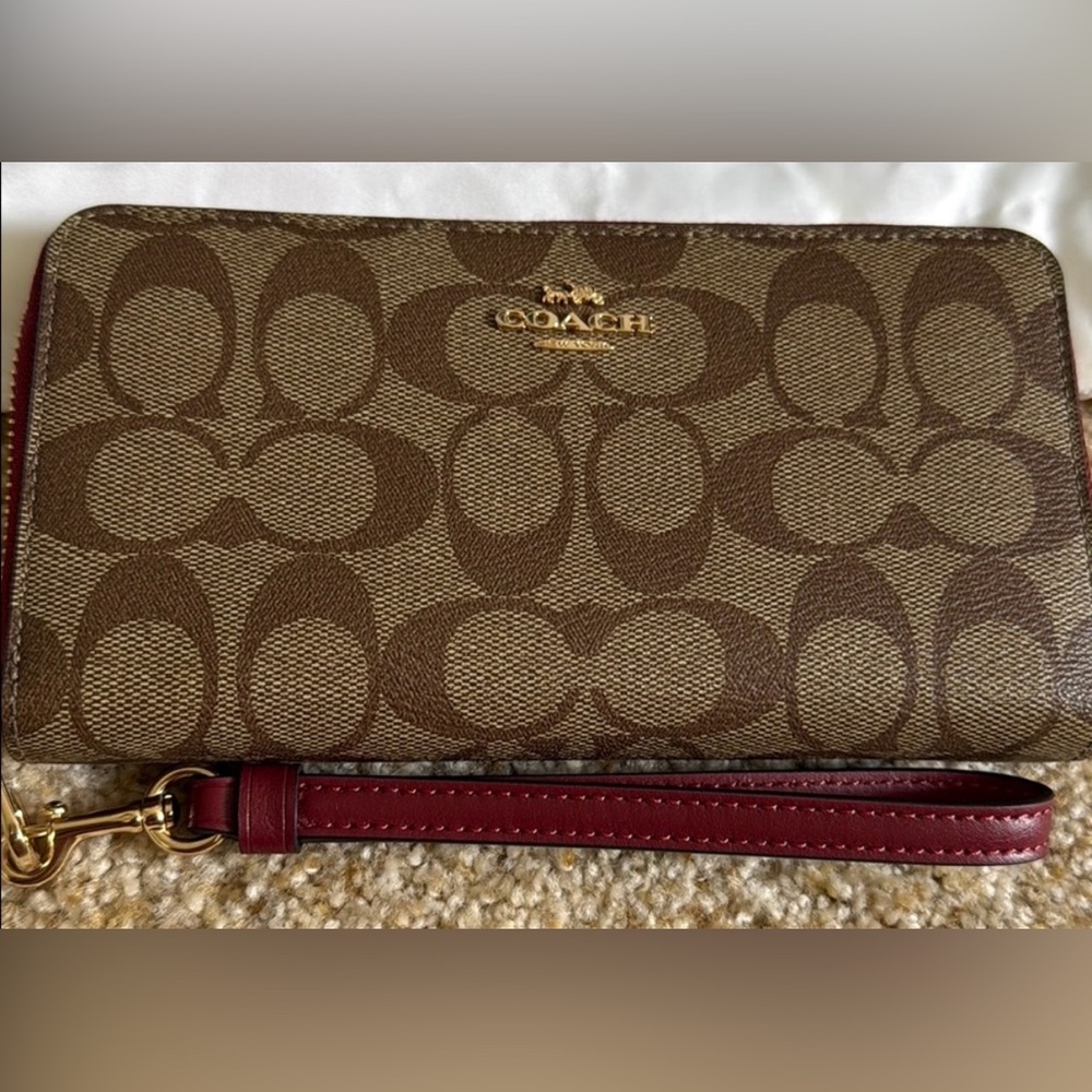 Coach Tan and Red Signature Accordion zip wallet.